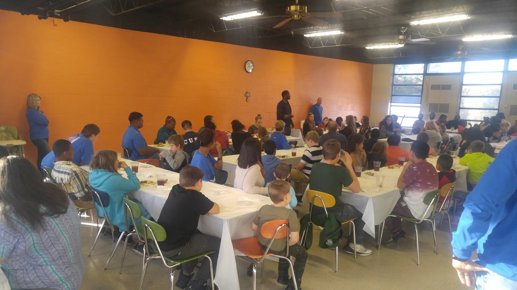 A full hall of families seated for the free C.A.N. Thanksgiving dinner