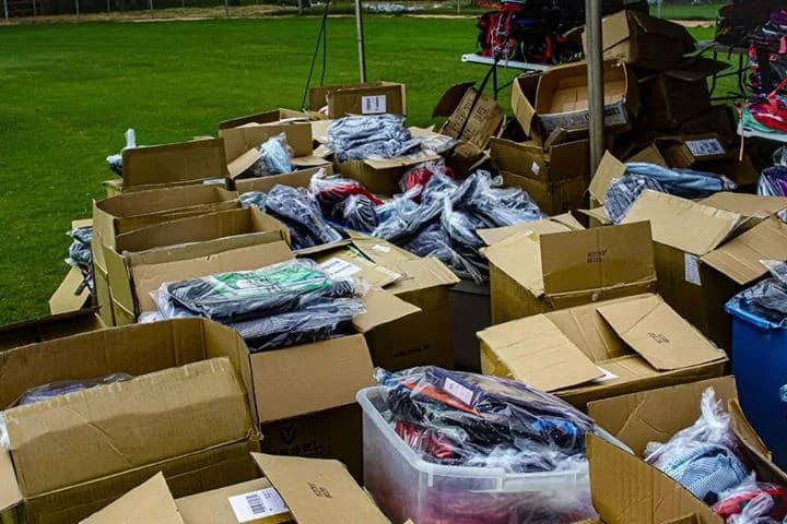 Boxes of donated school supplies gathered on the field before the give-away
