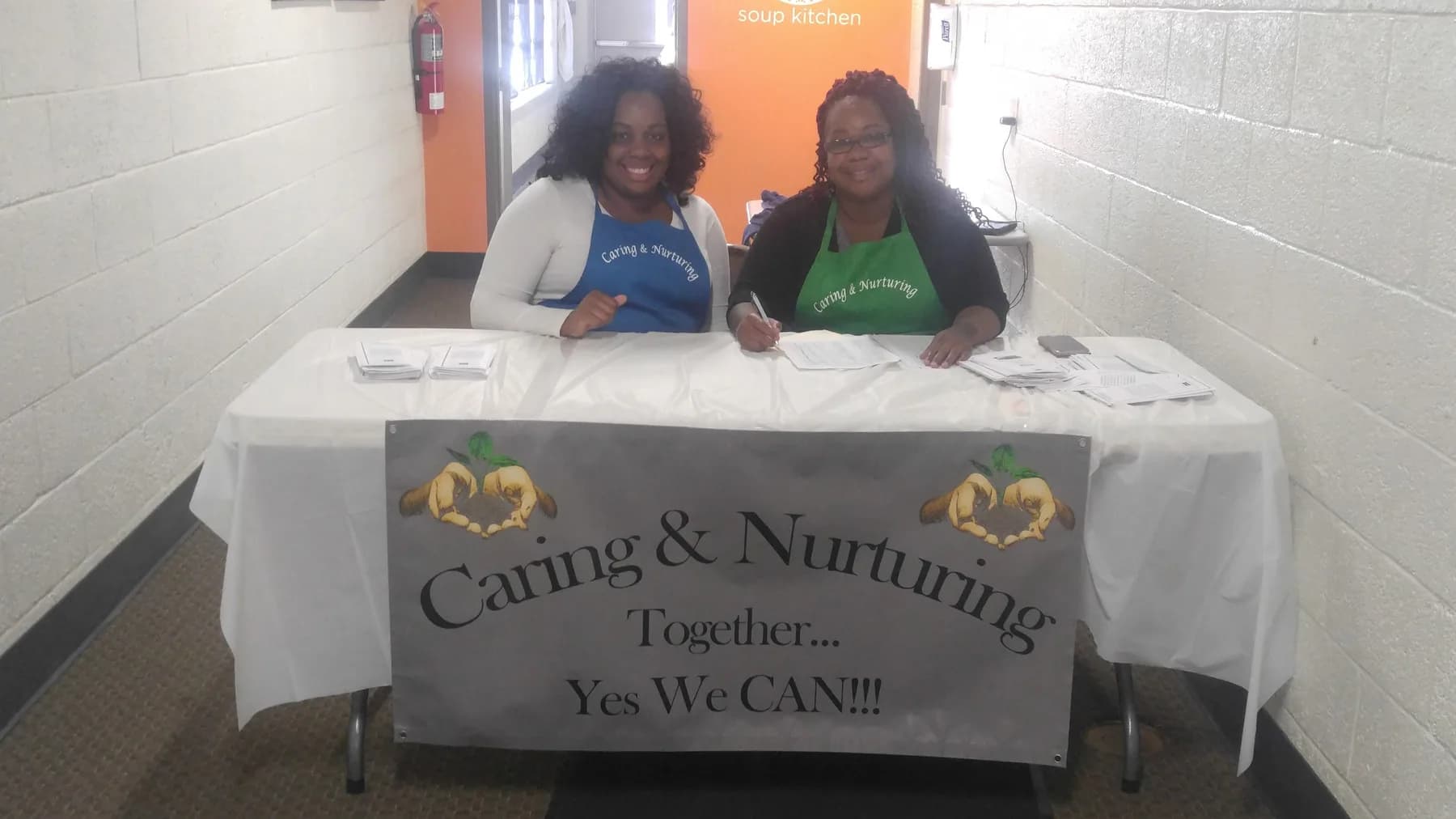 Volunteers at the Caring & Nurturing registration table before an event